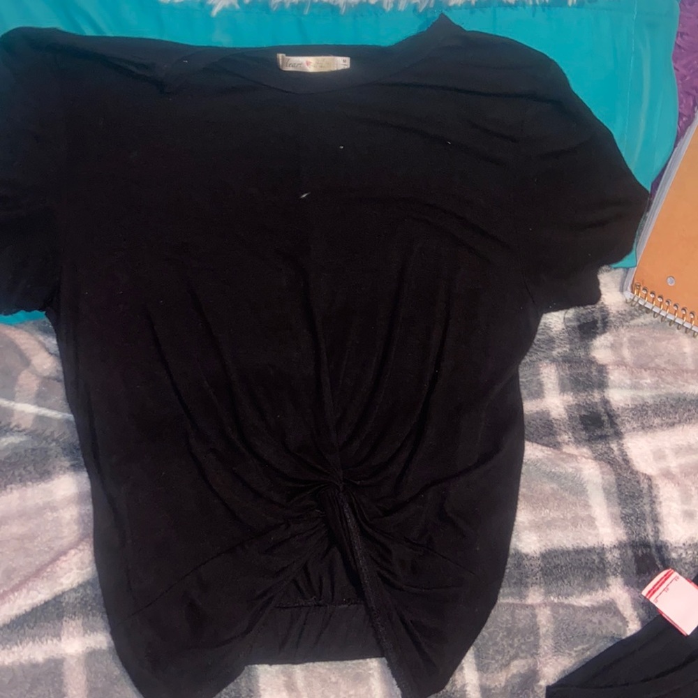 a black shirt. medium in girls. built in tie in front.